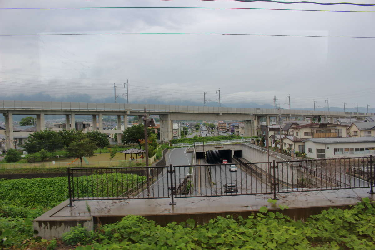 特急「ゆけむり」は北陸新幹線の高架をくぐり長野の市街地へ